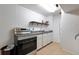 Efficient kitchen space with stainless steel range and ample cabinet storage, ready for your personal touch at 7930 S Kendall Ct, Littleton, CO 80128