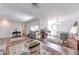 Open-concept living space with wood floors, modern lighting, and a versatile layout at 7930 S Kendall Ct, Littleton, CO 80128