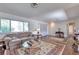 Comfortable living room featuring a large window, plush sofa, and stylish decor at 7930 S Kendall Ct, Littleton, CO 80128