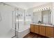 Bathroom featuring a double vanity, bathtub, and separate glass-enclosed shower at 10806 Crooke Dr, Parker, CO 80134