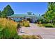 Community clubhouse featuring a green roof, stone accents, and manicured landscaping at 10806 Crooke Dr, Parker, CO 80134