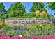 Stone sign for Bradbury Ranch community with colorful flower beds at 10806 Crooke Dr, Parker, CO 80134