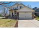 Two-story home featuring a two-car garage, manicured lawn, and inviting curb appeal at 10806 Crooke Dr, Parker, CO 80134
