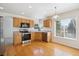 The Kitchen has wooden cabinets, stainless steel appliances, and hardwood floors at 10806 Crooke Dr, Parker, CO 80134