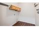Functional laundry room features wood-look floors, overhead storage, and washer hookups at 10806 Crooke Dr, Parker, CO 80134