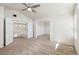 Open-concept living area with neutral paint, carpeting, and arched doorway to another room at 10806 Crooke Dr, Parker, CO 80134