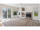 Light-filled living room with a sliding glass door and a cozy fireplace feature at 10806 Crooke Dr, Parker, CO 80134