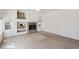 Spacious living room featuring a fireplace, large windows, and neutral carpeting at 10806 Crooke Dr, Parker, CO 80134
