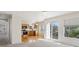 Open concept space with a view to the kitchen and access to the exterior patio at 10806 Crooke Dr, Parker, CO 80134