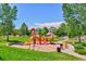 A colorful community playground with slides, swings, and climbing structures on a soft sand base at 10806 Crooke Dr, Parker, CO 80134