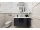 Modern powder room with floating vanity and patterned wallpaper at 7036 E Archer Pl, Denver, CO 80230