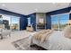 Main bedroom with fireplace, sliding doors to balcony and blue walls at 7036 E Archer Pl, Denver, CO 80230