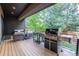 Outdoor deck with built-in grill and seating area at 7036 E Archer Pl, Denver, CO 80230