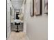 Bright hallway with a vanity and stylish wall art at 7036 E Archer Pl, Denver, CO 80230