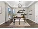 Bright home office with built-in shelves and hardwood floors at 7036 E Archer Pl, Denver, CO 80230