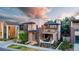 Modern two-story home with a balcony and landscaped front yard at 7036 E Archer Pl, Denver, CO 80230