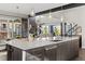 Modern kitchen with large island and breakfast bar at 7036 E Archer Pl, Denver, CO 80230