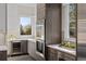 This kitchen features white countertops, stainless steel appliances, and custom wood cabinets at 7036 E Archer Pl, Denver, CO 80230