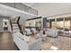 Open living room with high ceilings and modern staircase at 7036 E Archer Pl, Denver, CO 80230