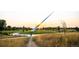 Paved pathway through park with tall sculpture in background at 7036 E Archer Pl, Denver, CO 80230