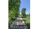 Paved pathway through a park with lush green grass at 7036 E Archer Pl, Denver, CO 80230