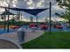 Modern playground with shade structures, play equipment, and picnic tables at 7036 E Archer Pl, Denver, CO 80230