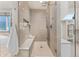 Large walk-in shower with glass enclosure, built-in bench, and multiple shower heads at 7036 E Archer Pl, Denver, CO 80230