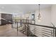 Spacious upper landing with hardwood floors and a modern light fixture at 7036 E Archer Pl, Denver, CO 80230