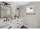 Modern bathroom featuring double vanity sinks, sleek black fixtures, and a glass walk-in shower at 1473 N Locust St, Denver, CO 80220
