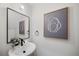 Stylish half bathroom with modern fixtures, a vessel sink, and decorative mirror at 1473 N Locust St, Denver, CO 80220