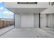 Two-car garage with concrete floor and white door at 1473 N Locust St, Denver, CO 80220