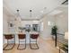 Modern kitchen features stainless steel appliances, a breakfast bar, and hardwood floors at 1473 N Locust St, Denver, CO 80220