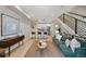 Open-concept living room with modern staircase, stylish furniture, and hardwood floors at 1473 N Locust St, Denver, CO 80220