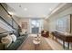 Comfortable living room with a modern staircase, sofa, chair, and lots of natural light from the balcony at 1473 N Locust St, Denver, CO 80220