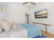 Stylish bedroom featuring a modern TV, floating desk, and comfortable bed with blue accents at 8615 W Berry Ave # 203, Littleton, CO 80123