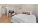 Well-lit bedroom with wood flooring, comfortable bedding, and a functional work area at 8615 W Berry Ave # 203, Littleton, CO 80123