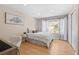 Cozy bedroom with natural light, wood floors, and a comfortable aesthetic at 8615 W Berry Ave # 203, Littleton, CO 80123