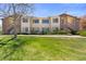 Inviting multi-Gathering property with well-maintained landscaping and a spacious grassy area in front at 8615 W Berry Ave # 203, Littleton, CO 80123