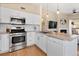 Stylish kitchen featuring stainless steel appliances, granite countertops, and easy access to the living area at 8615 W Berry Ave # 203, Littleton, CO 80123
