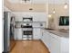 Well-lit kitchen featuring stainless steel appliances, granite countertops, and ample cabinet space at 8615 W Berry Ave # 203, Littleton, CO 80123