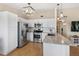 Bright kitchen featuring stainless steel appliances, granite countertops, and ample cabinet space at 8615 W Berry Ave # 203, Littleton, CO 80123