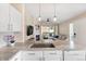 Open floor plan featuring a kitchen with granite counters and stainless appliances with an easy flow into the living area at 8615 W Berry Ave # 203, Littleton, CO 80123
