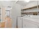 Modern laundry room with new appliances and functional shelving, offering convenience and style at 8615 W Berry Ave # 203, Littleton, CO 80123