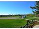 Enjoy the community park with a baseball field, green space, and mature trees on a sunny day at 8615 W Berry Ave # 203, Littleton, CO 80123
