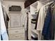 Well-organized walk-in closet with custom shelving and clothing racks for optimal storage solutions at 8615 W Berry Ave # 203, Littleton, CO 80123