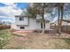 View of backyard with wood deck, patio and mature trees at 17802 E Bates Ave, Aurora, CO 80013