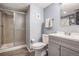 Bathroom featuring a glass door shower, commode, and vanity with sink at 17802 E Bates Ave, Aurora, CO 80013