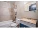 Bathroom featuring a shower-tub combo, commode, and vanity with sink at 17802 E Bates Ave, Aurora, CO 80013