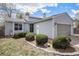 Charming home showcasing its light blue siding, well-manicured landscaping, and attached two-car garage at 17802 E Bates Ave, Aurora, CO 80013