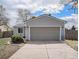 Two-car garage attached to a home featuring manicured landscaping and natural light at 17802 E Bates Ave, Aurora, CO 80013